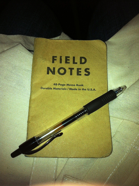 Photo of a worn Field Notes notebook with a black pen